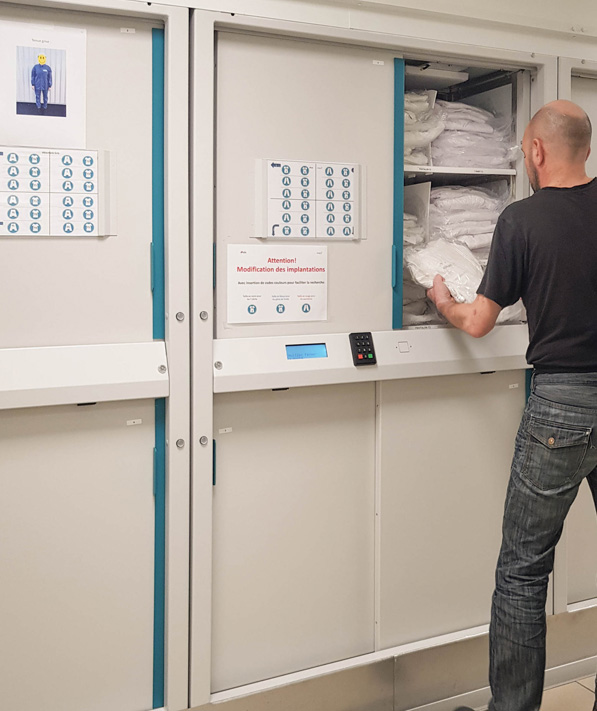 person taking clean uniform from laundry dispenser
